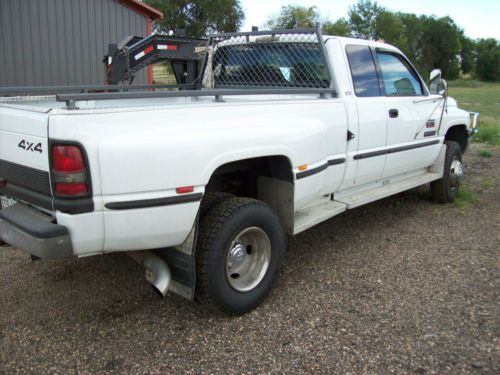 Diesel, 4x4, white, extended cab, 5 speed manual transmission, dual tires,