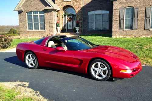 23,391 actual miles.has two tops, smoked glass and matching magnetic red ii