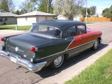 Red and gray 1956 oldsmobile eighty eight four door sedan