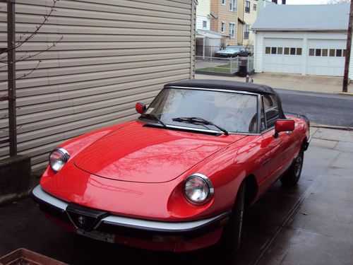 Red with wire wheels and roll bar