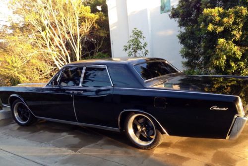 1966 hot rod lincoln continental suicide door. black on black.