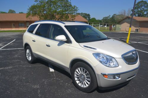 Pearl white buick enclave w/tan interior.  3rd row seating, rear dvd ent.