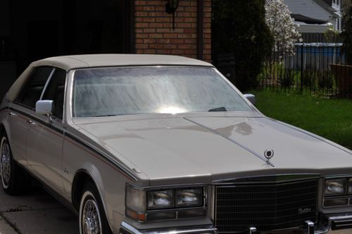 1984 beige cadillac seville automobile