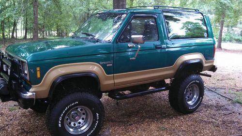 Custom built bronco ii , 6" lft, new33"tires. green goldtrim eddie bauer edition