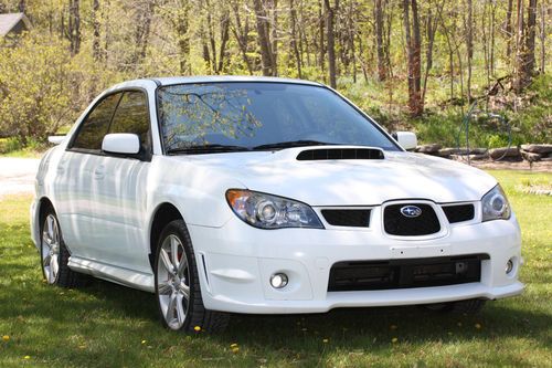 2006 subaru wrx.  very clean. alpine white.  full spt exhaust and other parts.