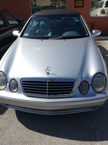 Silver convertible, black top, silver interior, new tires, serviced up to date.