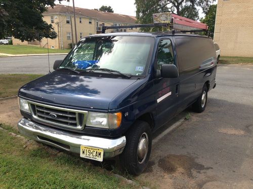 E-series van, used, blue, steel divider between the driver and the cargo area