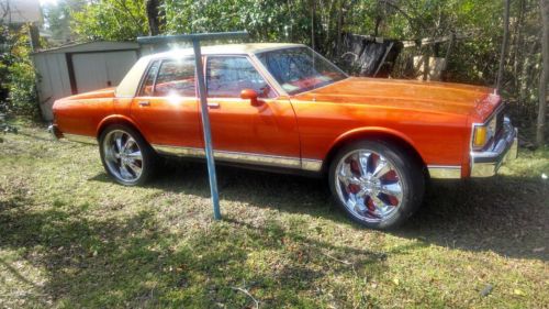 1985 chevrolet caprice classic sedan 4-door 5.0l kandy tangerine 24inch rims